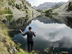 Fisherman fly fishing at lake Stock Footage