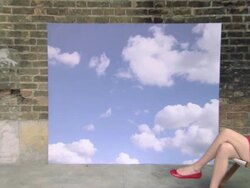 Zoom out from sky backdrop to girl in deckchair removing sunglasses Stock Footage