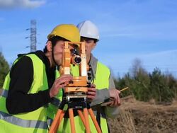Land surveyors on construction site Stock Footage