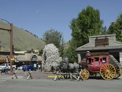 MS Beautiful stage coach rides in downtown center / Jackson Hole, Wyoming, United States Stock Footage