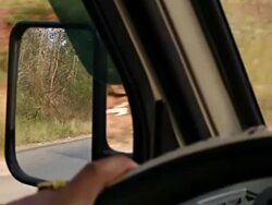CU POV SLO MO Shot of mirror of moving car with hands on wheel / Road from Luang Prabang to Nong Khio, Luang Prabang, Laos  Stock Footage