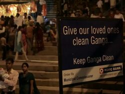 WS Ghats on river Ganges with sign in foreground / Varanasi, India Stock Footage