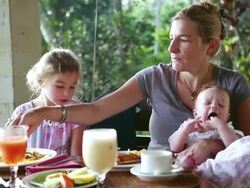 MS Shot of mother and children having breakfast on porch / Ubud, Bali, Indonesia Stock Footage