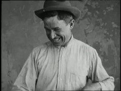 Will Rogers swings a lasso on stage. News Clip