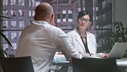 DS Two female doctors in meeting with male project leader Stock Footage