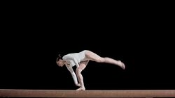 SLO MO Female gymnast performing flip on balance beam Stock Footage