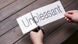 woman's hands cut paper by scissors on pattern wood plank Stock Footage