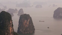 Morning mist Ha long Bay limestone karsts North Vietnam Asia Stock Footage