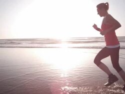 Jogging at the beach Stock Footage