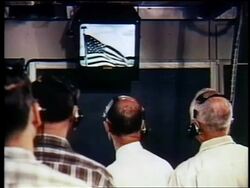 1962 REAR VIEW men in headsets watching American flag on TV / first satellite broadcast Stock Footage