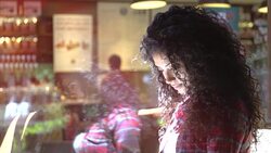 Curly hair and beautiful student reading book and drink coffee at campus cafe Stock Footage
