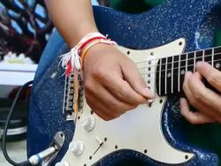 Lao men playing the Electric Guitar Stock Footage