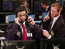 Busy stock brokers communicating over the phone in a Stock Exchange Stock Footage