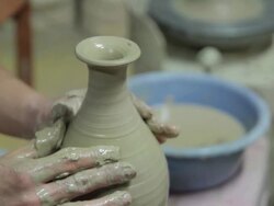 Shot of holding clay and making pottery shape with hands and pottery wheel Stock Footage