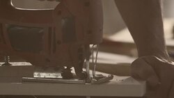 Electric jigsaw sawing piece of wood Stock Footage