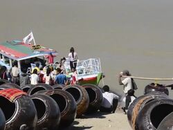 WS Shot of Men carrying large clay pots and passengers board ship on Ayeyarwadi river / Bagan, Mandalay Division, Myanmar Stock Footage