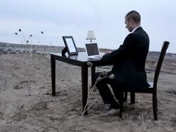 MS Young businessmand in black suit working on  his lap top while sitting at  table on top of  bluff in rural area  / Maple Grove, Minnesota, United States Stock Footage