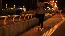 woman walking alone in street night Stock Footage