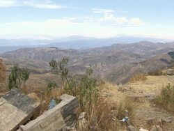 Oruro mountain ranges shot from rundown building on hill, Bolivia Stock Footage
