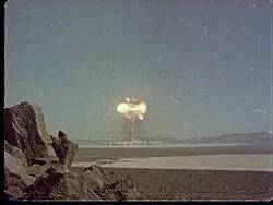 1950s WS Mushroom cloud forming after explosion in desert at Camp Desert Rock at Nevada Test Site / Nye County, Nevada, USA Stock Footage