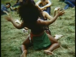 1969 MS ZI ZO Hippie couple dancing and lying down on grass at Woodstock music festival/ Bethel, New York, USA Stock Footage
