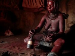 Indigenous Himba women from Namibia doing her cleaning ritual. Stock Footage