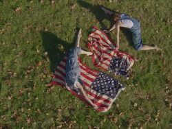 two women dancing with American flags Stock Footage