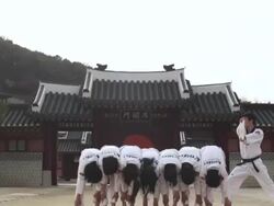 WS Man doing jumping kick and breaking wooden board with his hand  / Kyungkido, Bucheon, South Korea Stock Footage