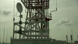 A communications worker attaches a safety rope before he climbs onto a tower. Stock Footage