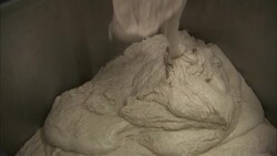 Dough pours out of a vat. Stock Footage