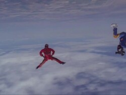 A skydiver spins headdown with a camera flyer filming him. Stock Footage