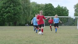 Children Playing a Game of Soccer Outdoors Stock Footage