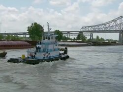 MS POV View of tugboat flowing on mississippi river in front of bridge / New Orleans, Louisiana, United States Stock Footage