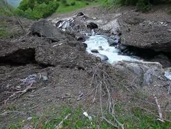 Old avalanche melting in spring valley Stock Footage