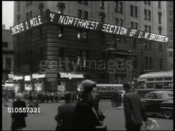 1950: KOREAN WAR: NEW YORK HOME FRONT: WS Electric news bulletin scrolling Korean Communists conflict, 'Walgreens' store, Time Square, New York. VS People standing on streets reading. LA MS Scrolling bulletin '...Troops drive back Koreans.' Instructional Video