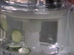 Woman cutting cucumber in blender Stock Footage