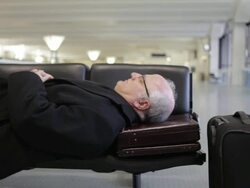 MS Middle aged traveling businessman resting on bench inside airport / Minneapolis, Minnesota, United States Stock Footage