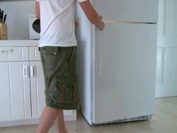 MS,  man opening empty fridge,  Harbour Island,  Bahamas Stock Footage