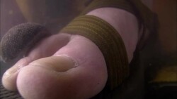 A leech slithers over a sandaled foot underwater. Stock Footage