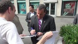 Chris Christie leaving the 'FOX & friends' show, signs for a fan and poses for a photo in New York City Stock Footage