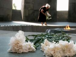 MS Old lady putting flowers in Garni Gorge temple  / Yerevan, Armenia Stock Footage