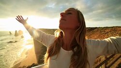 Caucasian female arms outstretched at sunset Stock Footage