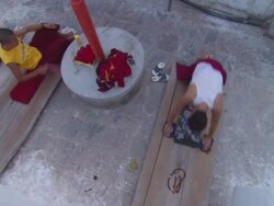 MS PAN Monk standing up and laying down on  wood plank  / Kathmandu, Central, Nepal Stock Footage
