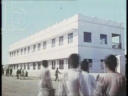 FLM PS0659 9 Bahrain 1960s - Boys going to school and playing basketball. Stock Footage
