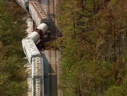 Aerial cars of derailed train strewn across tracks / near Clement Harbor, Mississippi Stock Footage