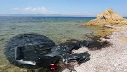 Life jackets and remains of boats left by Syrian migrants fleeing the war and escaping to Europe, landing on the Greek island of Lesvos on the north coast at Efthalou. Up to 4,000 migrants a day are landing on the island and overwhelming the authorities. T Stock Footage