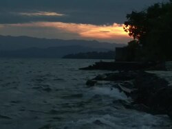 The sunset behind the mountains and the sea coast Stock Footage