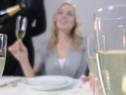 Waiter pouring champagne for woman, rack focus Stock Footage