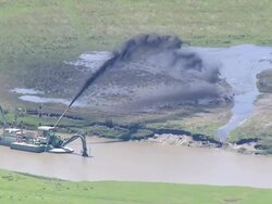 AERIAL WS View of canal clean machine  / Eiderstedt, Schleswig-Holstein, Germany Stock Footage