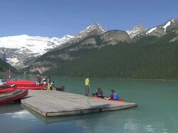 WS People enjoying and boating at small boat dock of Louise Lake in Banff Nationalpark / Lake Louise, Alberta, Canada Stock Footage